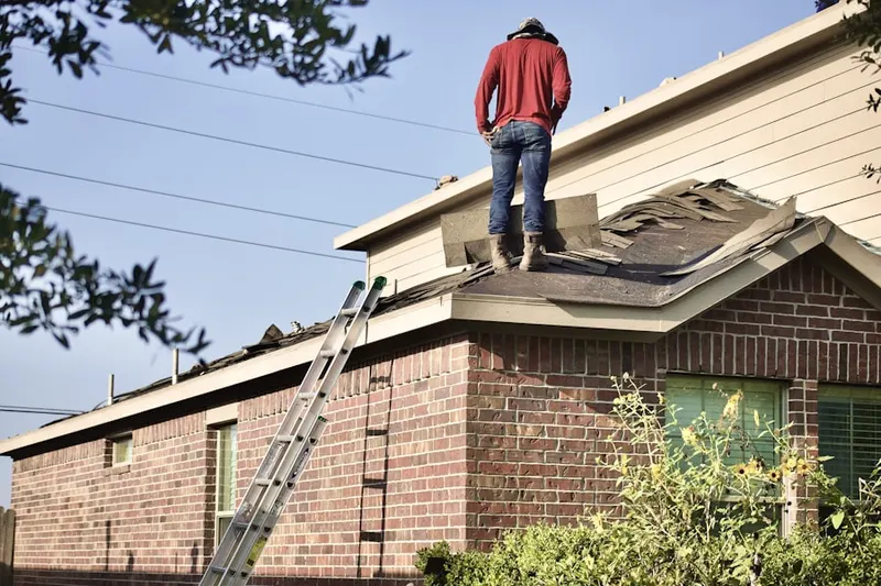 Professional roofer working on a residential roof in PiÃ±on Hills